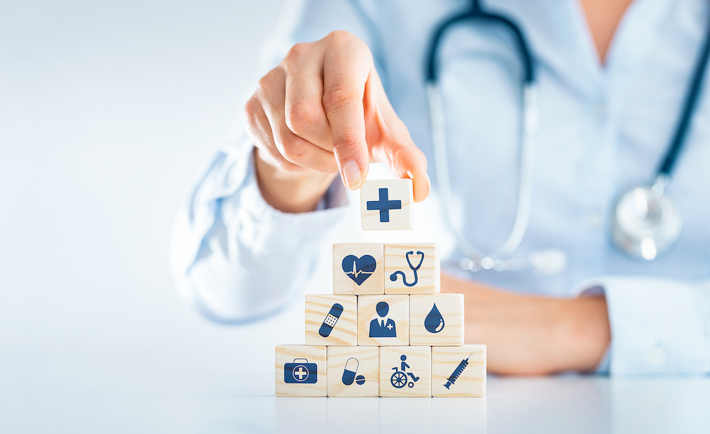 Hand,Arranging,Wood,Block,With,Healthcare,Medical,Icon.,Health,Insurance